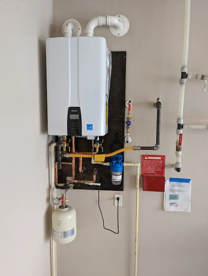 Professional plumber installing copper piping in a Menomonie home